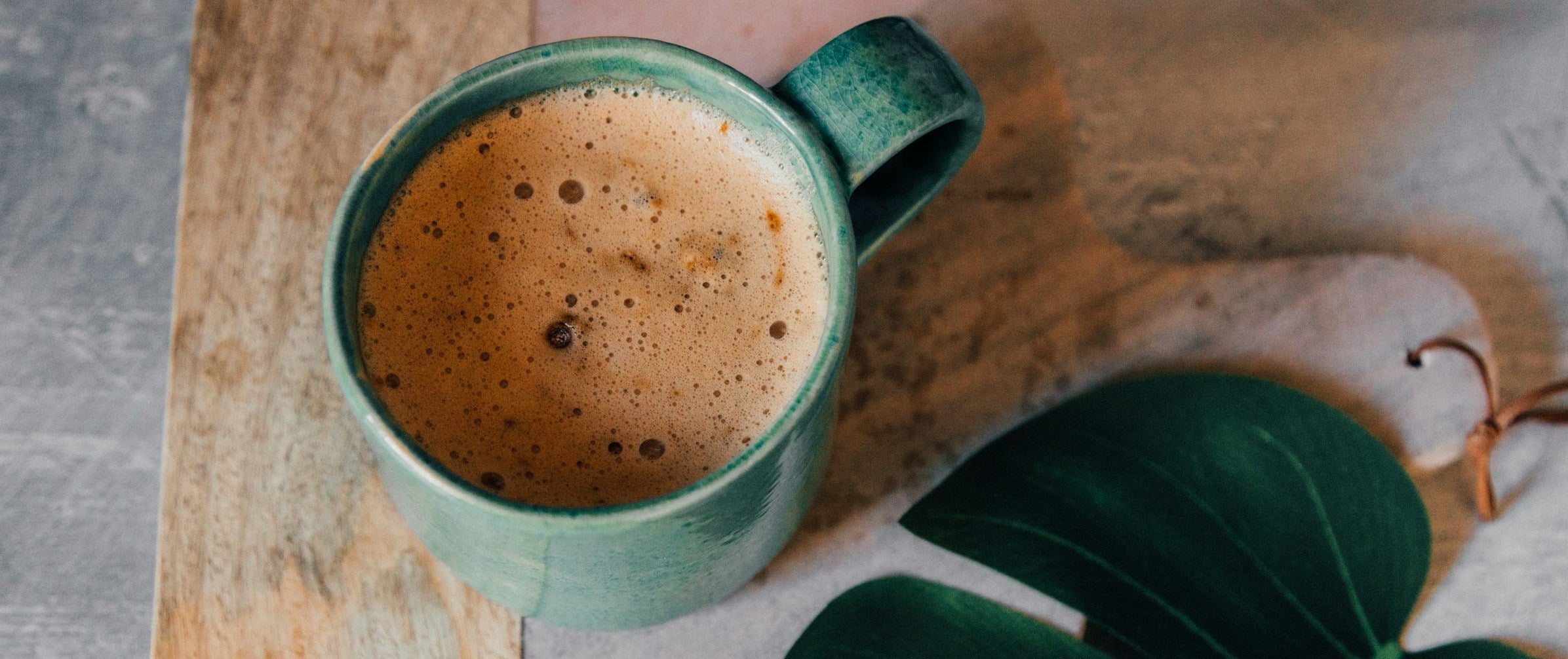 Green ceramic mug with coffee